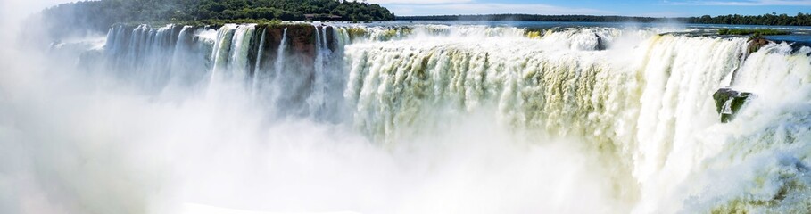 Panoramic view of sunshine falls landscape, Devil's Throat of Iguazu (Iguacu) waterfall in Argentina. Majestic powerful natural water cascade, summer sun day. World nature concept. Copy ad text space