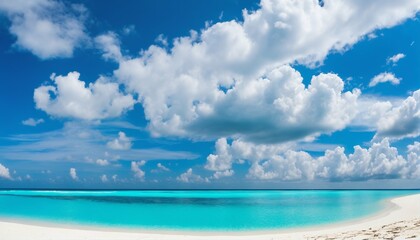 Fototapeta na wymiar Sandy beach on sunny day with white sand and rolling calm wave of turquoise ocean, white clouds in blue sky background