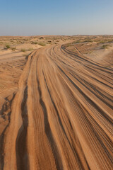 Tyre tracks in the sand of the Rub Al Khali desert.