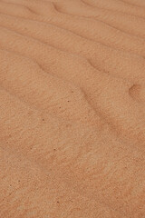 Macro of orange desert sand waves .