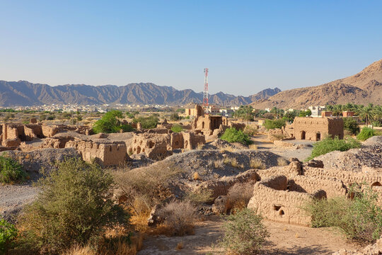 Panorama of the old citadel of Tanuf houses built with straw and mud on the horizon surrounded by mountains. Oman.