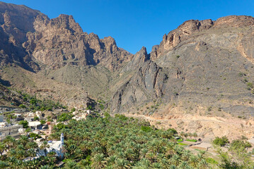 Agricultural village and white mosque in the mountains of Wadi Ghul. Oman.