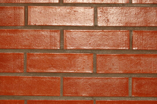New built brick wall with sun reflecting off surface