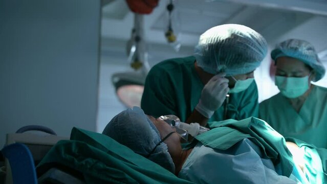 Doctor doing resuscitate a patient in oxygen mask resting on Bed in a hospital, CPR Cardiopulmonary resuscitation process