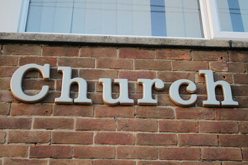 Words "Church" attached to a brick wall