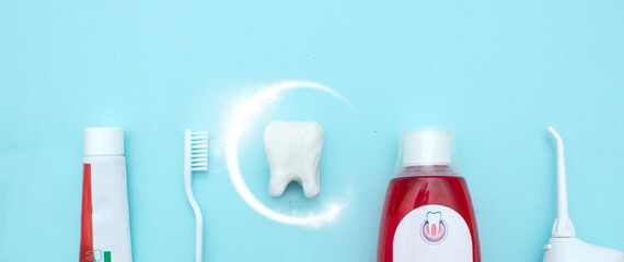 Close up of a toothbrush, toothpaste, irrigator, mouthwash for teeth, dental mirror with white...