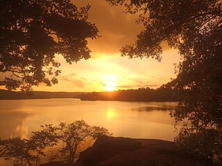 sunset on the lake with orange sky.