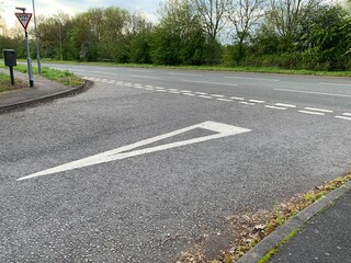Picture of a UK road junction give way signs and markings
