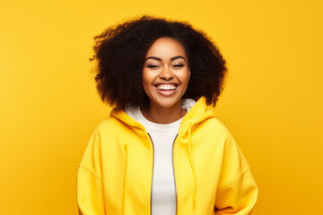 Obraz na płótnie Canvas Young African American Woman with Afro Hairstyle, Happy and Stylish in Yellow Sweater, Closeup Portrait