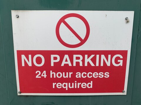 Red and white UK sign "No parking 24 hour access required"