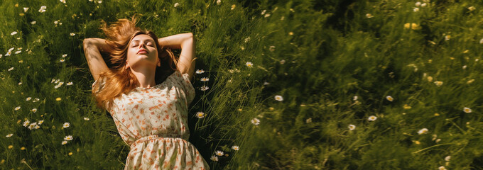 Happy woman enjoying life and nature. Resting in grass in green garden, above top view. Woman lying down relaxing in the nature. Lazy girl day dreaming outside in the park. Happy calm healthy  - obrazy, fototapety, plakaty