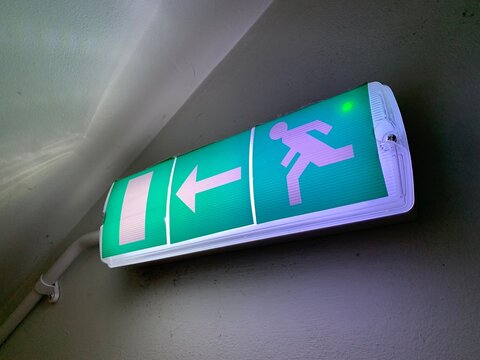 Illuminated emergency exit sign, taken on stairs in a high rise building