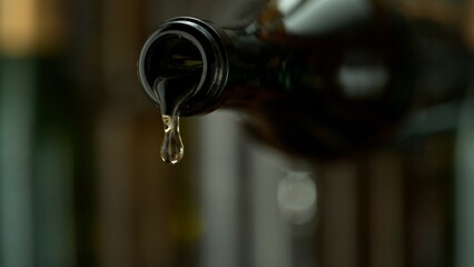 Pouring White Wine from a Bottle into Glass. Close-up.