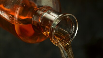 Bottle of Whiskey with Pouring Liquid.