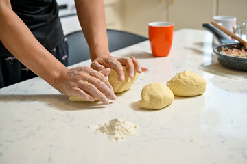 hands kneading dough
