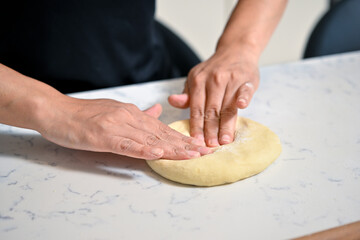 person kneading dough