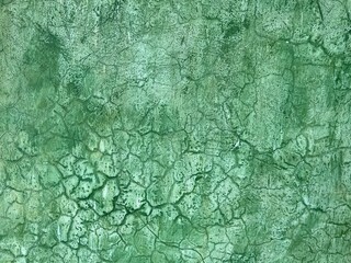 Green plaster wall with crackle texture background in Oaxaca, Mexico.