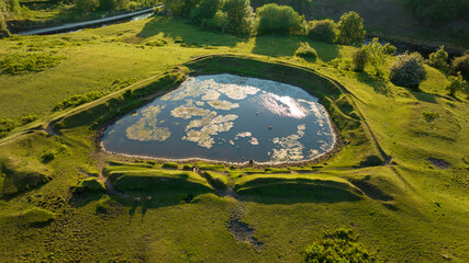 Lake and pond on the plateau. A lake in a green mountain landscape. Lake view taken with a drone. thermal spa