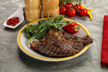 Grilled chuck roll steak with arugula