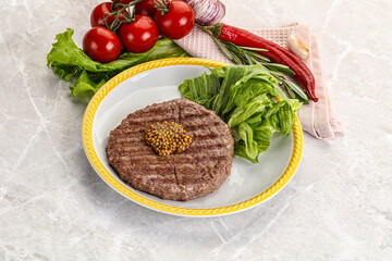 Frilled beef burger cutlet with iceberg