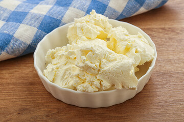 Italian soft mascarpone cheese in the bowl
