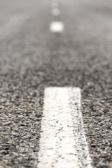 Car asphalt road in the middle of the hot empty Kazakh steppe, asphalt texture on the highway