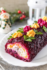 Festive layered shuba salad. Traditional Russian Christmas New Year vegetable salad roll with herring and boiled vegetables. Copy space.