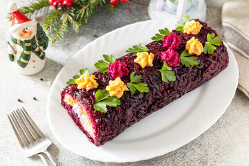 Festive layered shuba salad. Traditional Russian Christmas New Year vegetable salad roll with herring and boiled vegetables.