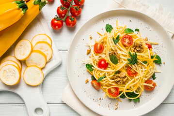 yellow zucchini salad, with cherry, vegetarian food, sliced into strips, homemade,