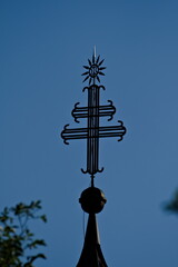 Religion symboles on the top of a church in Slovenia near to lake Bohinj. Metal double cross.
