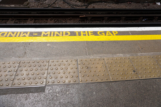 London, England, July 19, 2023, 'Mind the Gap', yellow painted floor sign, notice for passenger safety