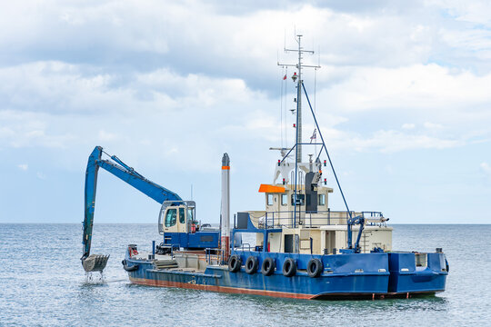 ship with excavator for dredging the entrance to the port