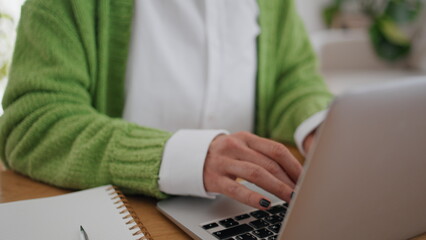 Woman hands typing laptop keyboard apartment desk closeup. Student girl learning