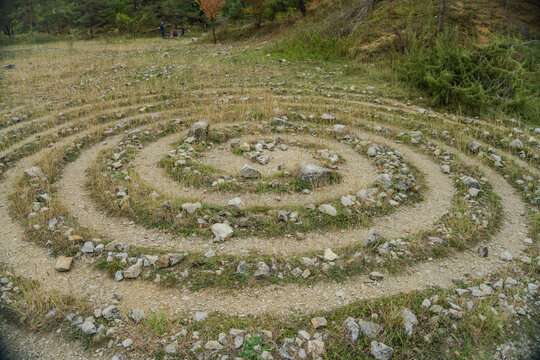 Circular labyrinths on the ground of grass and stones near the Konepruske cave.