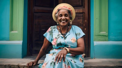 Türaufkleber Cuban elderly woman with her flowered clothes happy enjoying an afternoon in Havana, Caribbean lifestyle, flowers and intense colors © Juan Gumin