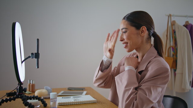 Visage influencer greeting blog subscribers to phone. Blogger woman streaming