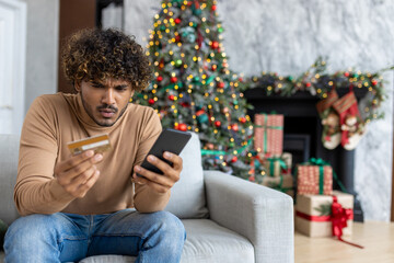 Cheated and upset Christmas man in living room near decorated Christmas tree, rejected and wrong...