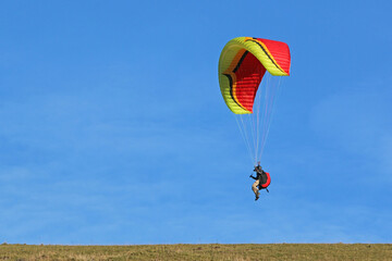 	
Paraglider flying from a hill	