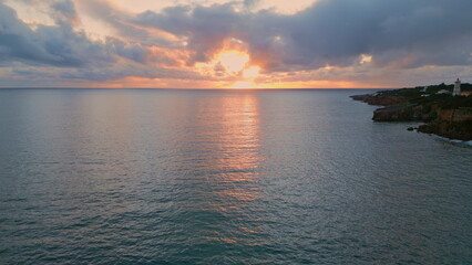 Dramatic cloudy marine panorama drone view. Sunlight breaking thunder clouds