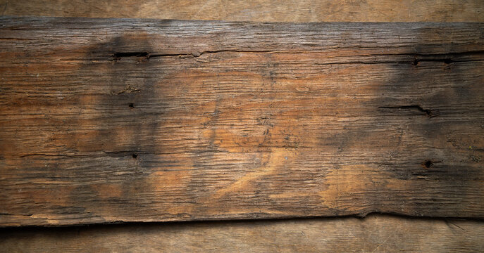An old board from a pirate ship.Wooden background made of vintage wood.The wreck of an old ship.