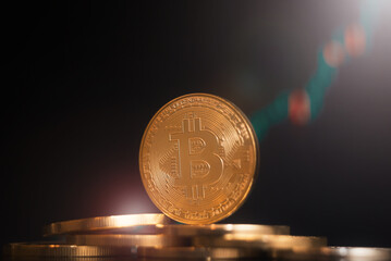 Bitcoin coins against the backdrop of a growing market.
BTC coin macro photography on a black background. BTC price goes up
