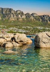 Camps bay beach town, and the Twelve Apostles mountain on atlantic ocean from Fourth Beach, Clifton, Cape Town, South Africa