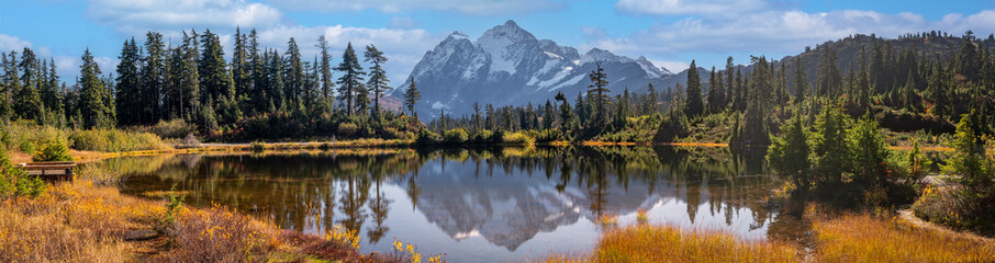 Picture Lake with snow-capped Mount Shuksan in the background showing autumn colors. Home to one of the most photographed vistas in America and even more special during the fall season.  - obrazy, fototapety, plakaty