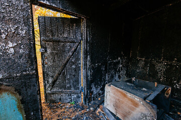 Consequences of fire. Completely burnt wooden house