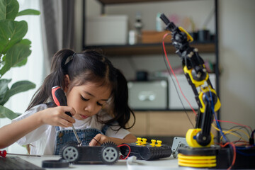 STEM education concept. Asian young girl learning robot design.