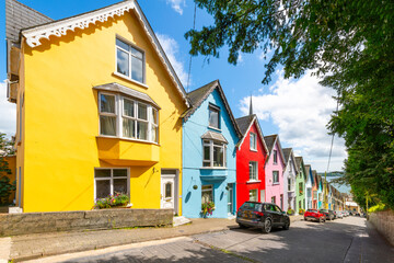 The picturesque and colorful Deck of Cards, a row of brightly painted townhomes in the coastal town of Cobh, Ireland, Cork County.	