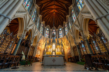 Interior view showing stained glass windows and arches architecture of the St. Colman's Cathedral Church of St Colman, or Cobh Cathedral in the port city of Cobh, Ireland.