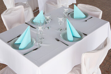 Set table with plates, glassesy, cutlery and napkins
