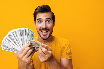 Man success rich cash business money dollar hand surprised happy yellow background smiling finance...