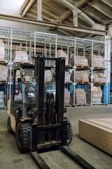 Forklift truck in industrial warehouse building